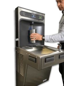 A image of a person using a contactless water bottle refill station