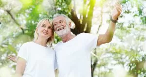 Older couple outdoors who appear to be happy 